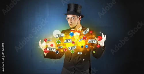 фотография Young illusionist in tails hold between hands gambling staffs with super power