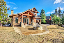 Home Exterior With Spacious Back Patio, Hot Tub And Barbecue.