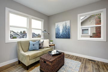 Wall Mural - Cozy seating area with a rattan trunk coffee table and an ivory sofa.