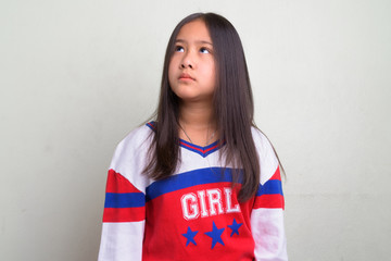 Portrait of young cute Asian girl wearing stylish clothes