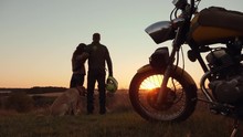 Attractive Couple With Dog Watching The Sunset