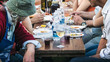 people eating in a town festival, horizontal image of a typical outdoor dinner (convivial moment of italian culture)