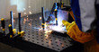© NDABCREATIVITY - man welds at the factory working in metal industry