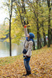 Cheerful young woman dancing in autumn park