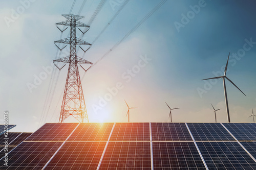 Fotografía Solar panels with electricity pylon and wind turbine Clean power energy concept