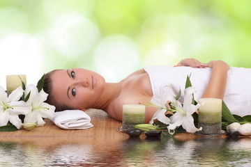 woman lying down relaxing on a massage bed at spa