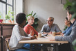 © ReeldealHD images - Group of coworkers having a meeting in a cafe
