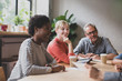 © ReeldealHD images - Group of coworkers having a meeting in a cafe