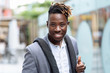 © Chernenko Timofey - Young african american man success sign doing positive gesture with hand, thumbs up smiling and happy