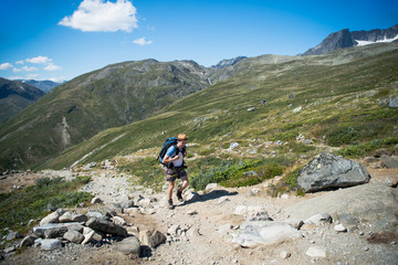 male traveler hiking on Besseggen ridge in Jotunheimen National Park, Norway