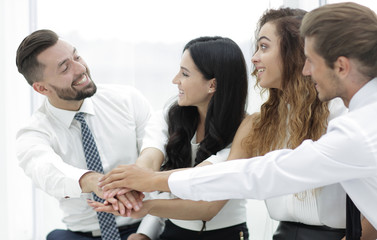 Canvas Print - Close-up of business partners making pile of hands