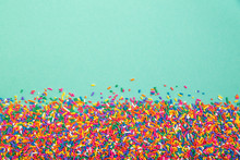 Colorful Sprinkles On Bottom Of Green Background