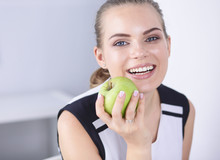 Young Beautiful Smiling Girl With A Green Apple In Hands