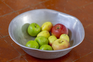 Wall Mural - homemade apples from the garden in an enamel basin on the floor. your garden and harvest the apples. organic apples