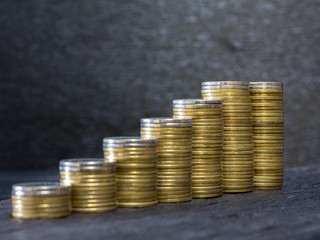 coins stack on the black wooden table ,growth business concept