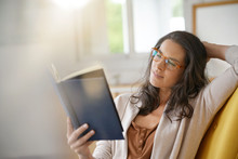 Brunette Woman At Home Reading Book