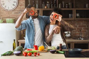 Wall Mural - Happy black couple having fun in loft kitchen