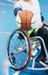 Disabled sport men in action while playing indoor basketball