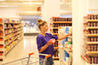 © lado2016 - Woman choosing a dairy products at supermarket