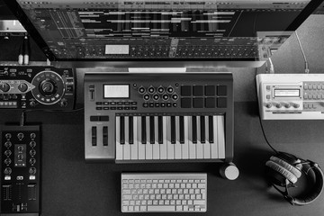 Poster - Home music studio - dj and producer equipment on the black table in monochrome color