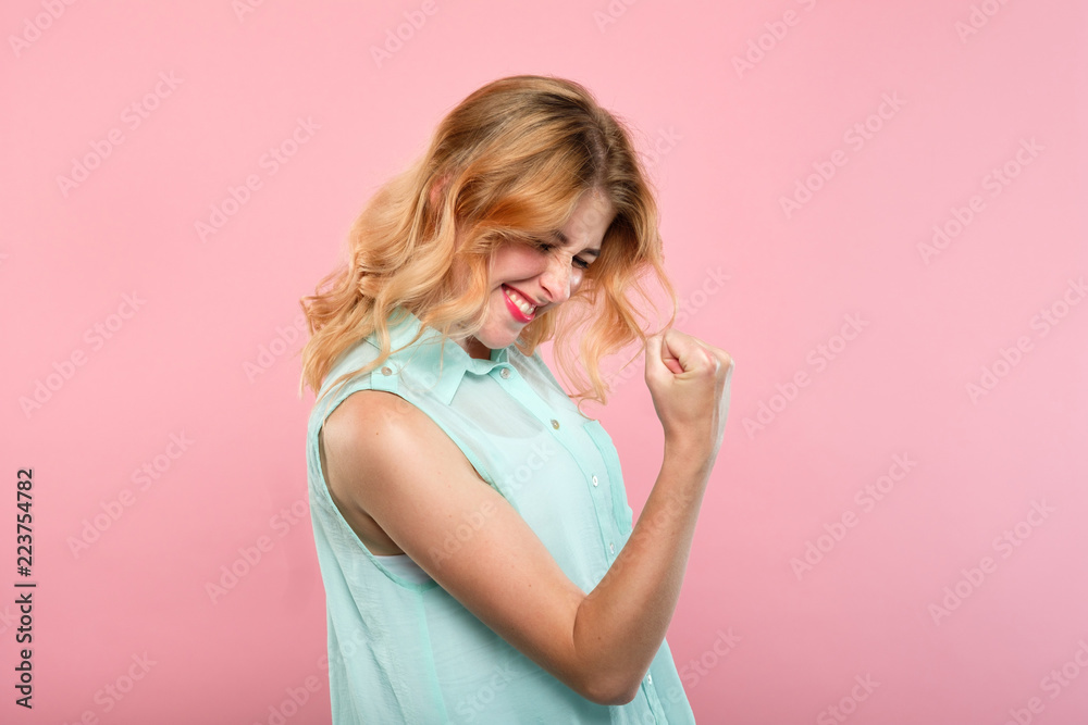 yes success and achievement. happy joyful smiling girl making a win gesture. excited thrilled woman portrait on pink background. - obrazy, fototapety, plakaty 