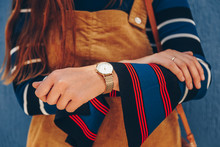 Close Up, Young Fashion Blogger Wearing A Corduroy Dress And A White And Golden Analog Wrist Watch. Checking The Time, Holding A Beautiful  Leather Purse. Street Style Fashion Details. 