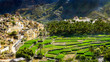 The beautiful mountain village of Balad Sayt sits in front of green fields in Wadi Bani Awf, Oman