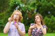 © Voyagerix - Couple blowing soap bubbles, having fun