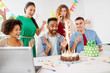 corporate, celebration and people concept - happy business team with birthday cake and gifts greeting male colleague at office party