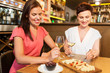 © Syda Productions - leisure, people and lifestyle concept - happy women eating snacks at wine bar or restaurant