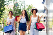 © Syda Productions - sale, consumerism and people concept - happy young women with shopping bags walking along city street