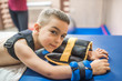 © Ivan - little boy lying on stomach during physiotherapy and look at camera