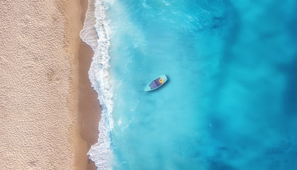 Wall Mural - boat on the water surface from top view. turquoise water background from top view. summer seascape f