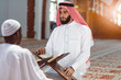 © FS-Stock - Muslim men praying with holy books in mosque