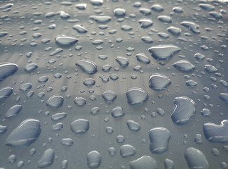 Water drop  of rain on a blue car background