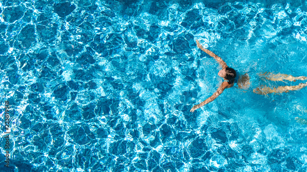 Aerial drone view of active girl in swimming pool from above, yong woman swims in blue water, tropical vacation, holiday on resort concept
 - obrazy, fototapety, plakaty 