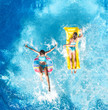 © Iuliia Sokolovska - Aerial drone view of children in swimming pool from above, happy kids swim on inflatable ring donut and mattress, girls have fun in water on family vacation on holiday resort