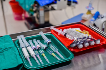 Medicine syringe and needle preparing for anesthesia in operating room.