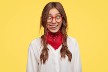 Photo Of Crazy Girlfriend Makes Funny Face, Crosses Eyes And Sticks Out Tongue, Plays Fool, Doesnt Want To Be Responsible, Being In Good Mood, Models Indoor Against Yellow Studio Background.