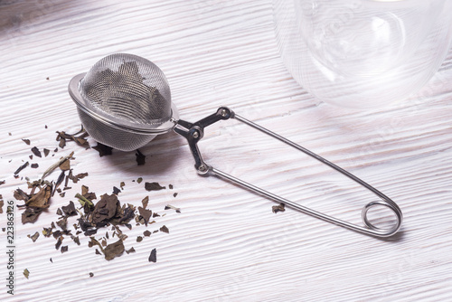Fotografia, Obraz Double walled glass with tea and stainless steel tea infuser