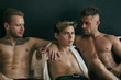 Three sexy guys on the bed.