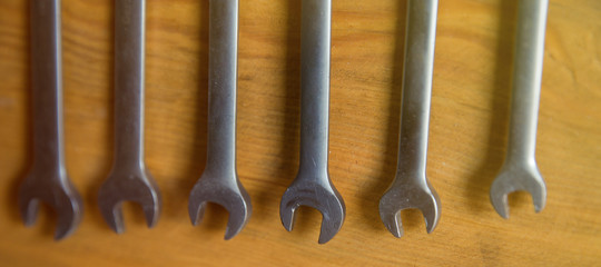 Wrenches on wooden background. Tools for working with machinery