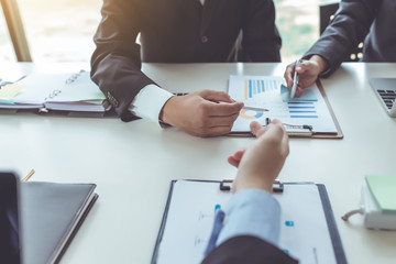 Group of business people meeting analyzing financial documents