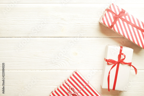 Three Christmas Presents Wrappend In Red And White Paper Tied With