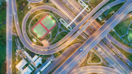 Wall Mural - Aerial view highway road circle or intersection at dusk for transportation, distribution or traffic background.