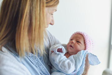 Wall Mural - Grandparent meeting newborn baby at hospital