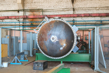 Wall Mural - Large metal iron distillation column for separation of substances into fractions in the industrial premises of the shop at an oil refinery, chemical, petrochemical plant