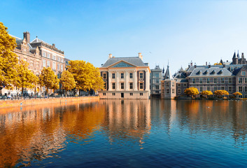 Wall Mural - city center of Den Haag - Dutch pairlament, Mauritshuis and with reflections in pond, Netherlands at fall