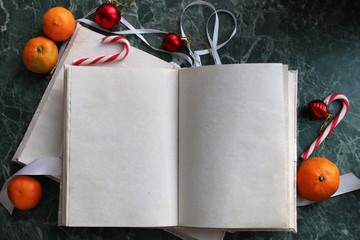 Canvas Print - pages opened vintage book on green marble countertop