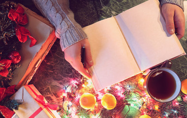 Wall Mural - man with a blank book in his hands for the New Year's table with